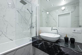 Shower with bathtub and black ceramic sink