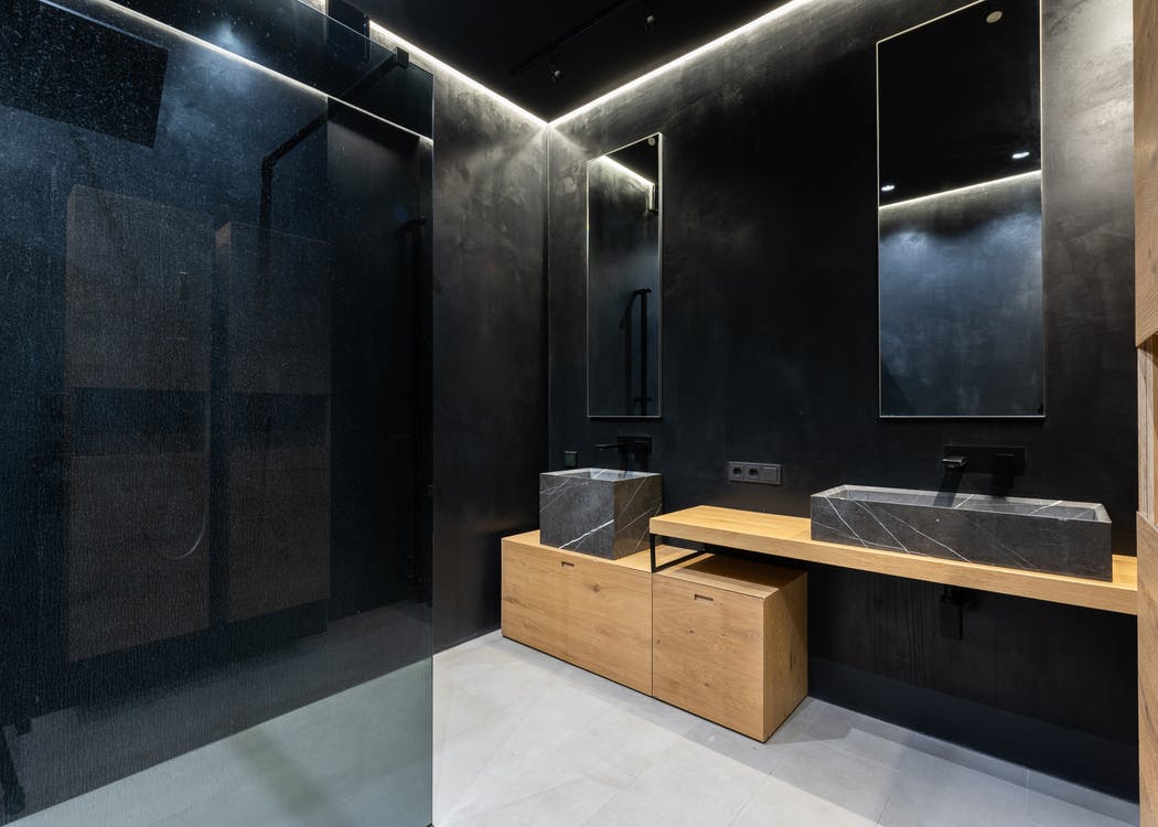 Black bathroom with wooden cabinet